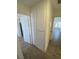 Spacious hallway with storage and doorways, featuring tile and carpet flooring at 1501 Wintergreen Dr, Las Vegas, NV 89128