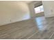 The room features wood-look tile flooring, white walls, and a large window at 1501 Wintergreen Dr, Las Vegas, NV 89128