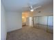 Spacious bedroom featuring neutral carpet, ceiling fan, and sliding closet doors at 1501 Wintergreen Dr, Las Vegas, NV 89128