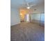 Spacious bedroom featuring neutral carpet, ceiling fan, and sliding closet doors at 1501 Wintergreen Dr, Las Vegas, NV 89128