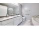 Bright bathroom featuring a double sink vanity, soaking tub, and marble countertops for a luxurious feel at 1551 Echo Falls Ave, Las Vegas, NV 89183