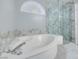 Luxurious bathroom with an oversized tub, glass shower, and marble accents offering a spa-like experience at 1551 Echo Falls Ave, Las Vegas, NV 89183