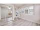 Bedroom with ample natural light, grey wood floors, and closet with mirrored doors at 1551 Echo Falls Ave, Las Vegas, NV 89183