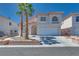 Charming two-story home with a two car garage, desert landscaping, and two palm trees at 1551 Echo Falls Ave, Las Vegas, NV 89183