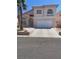 Charming two-story home with a spacious two-car garage and desert landscaping at 1551 Echo Falls Ave, Las Vegas, NV 89183