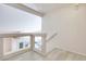 Second floor hallway with glass and white wood railings overlooking the kitchen below at 1551 Echo Falls Ave, Las Vegas, NV 89183