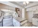Bright kitchen featuring an island, white cabinetry, and grey wood floors at 1551 Echo Falls Ave, Las Vegas, NV 89183