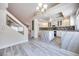 Open-concept kitchen with stainless steel appliances, center island, and an adjacent staircase at 1551 Echo Falls Ave, Las Vegas, NV 89183