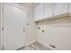 Efficient laundry room with storage cabinets and exterior access door at 1551 Echo Falls Ave, Las Vegas, NV 89183