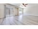 Open living room with sliding glass door, ceiling fan and grey wood floors at 1551 Echo Falls Ave, Las Vegas, NV 89183
