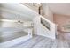 Bright living room with grey wood floors, open staircase, and ample natural light at 1551 Echo Falls Ave, Las Vegas, NV 89183