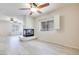 Bright open living room features a fireplace, ceiling fan, and windows for natural light at 1551 Echo Falls Ave, Las Vegas, NV 89183