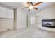 Expansive living room featuring a fireplace, ceiling fan, and plenty of natural light at 1551 Echo Falls Ave, Las Vegas, NV 89183