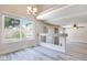 Spacious living room featuring a large window, ceiling fan, and sliding glass door at 1551 Echo Falls Ave, Las Vegas, NV 89183