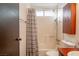 Bathroom with shower-tub combination with neutral striped curtain at 1728 S Christy Ln, Las Vegas, NV 89142