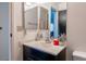 Bathroom vanity featuring dark wood cabinets, ample counter space, and neutral decor at 1728 S Christy Ln, Las Vegas, NV 89142