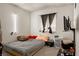 Bedroom featuring a window with curtains, a bed, and mounted TV at 1728 S Christy Ln, Las Vegas, NV 89142