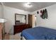 Bedroom with a bed and dresser plus personal items hung on the wall at 1728 S Christy Ln, Las Vegas, NV 89142