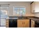 Bright kitchen featuring modern cabinets and a sleek black faucet and sink at 1728 S Christy Ln, Las Vegas, NV 89142