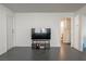 Minimalist living room featuring dark tile floors and a modern entertainment center at 1728 S Christy Ln, Las Vegas, NV 89142