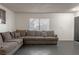 Comfortable living room with a large sectional sofa and natural light from the window at 1728 S Christy Ln, Las Vegas, NV 89142