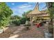 Charming backyard features a stone fountain, patio area, and lush landscaping, perfect for outdoor enjoyment at 1803 Candle Bright Dr, Henderson, NV 89074