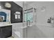 Well-lit bathroom showcases a vanity with sink, a shower with glass door, and neutral tiling at 1803 Candle Bright Dr, Henderson, NV 89074
