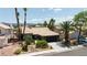 Charming single-story home with a well-manicured front yard and mature palm trees at 1803 Candle Bright Dr, Henderson, NV 89074