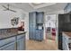 Stylish kitchen featuring blue cabinetry, granite counters, and seamless transition into dining and living areas at 1803 Candle Bright Dr, Henderson, NV 89074