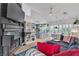 Bright living room featuring vaulted ceiling, fireplace, and views into kitchen and patio at 1803 Candle Bright Dr, Henderson, NV 89074