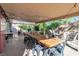 Spacious covered patio with an oversized dining table, and a cozy lounge area, perfect for entertaining at 1803 Candle Bright Dr, Henderson, NV 89074