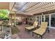 Inviting outdoor patio with lounge chairs, pergola, and string lights, ideal for relaxation and entertaining at 1803 Candle Bright Dr, Henderson, NV 89074