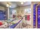 Charming bathroom with a vibrant blue tile shower, double sinks, and decorative windows at 2045 S Tenaya Way, Las Vegas, NV 89117
