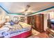 Comfortable bedroom with a ceiling fan, large wardrobe, and blue trim at 2045 S Tenaya Way, Las Vegas, NV 89117