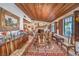 Beautiful dining room with a hardwood ceiling, and a fireplace in the background at 2045 S Tenaya Way, Las Vegas, NV 89117