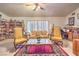 Inviting living room featuring bookshelves, a decorative rug, and abundant natural light at 2045 S Tenaya Way, Las Vegas, NV 89117