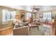 Bright living room featuring neutral decor, comfortable seating, and large windows that let in natural light at 2045 S Tenaya Way, Las Vegas, NV 89117