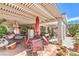 Covered patio with multiple seating areas and outdoor decor at 2045 S Tenaya Way, Las Vegas, NV 89117