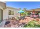 Charming patio area features brick pavers, comfortable seating, and a shaded pergola perfect for outdoor entertaining at 2045 S Tenaya Way, Las Vegas, NV 89117