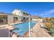 Inviting backyard pool features a spacious patio area, perfect for lounging and entertaining with a two-story home at 2045 S Tenaya Way, Las Vegas, NV 89117