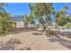 Landscaped side yard showcasing drought-tolerant landscaping, mature trees, and a rock garden at 2045 S Tenaya Way, Las Vegas, NV 89117