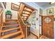 Classic wood staircase with decorative display and charming window detail creates inviting home entry at 2045 S Tenaya Way, Las Vegas, NV 89117