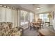 Bright sun room with a table and four chairs, with large windows offering natural light at 2045 S Tenaya Way, Las Vegas, NV 89117