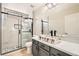 Modern bathroom featuring marble-look shower, grey vanity, and stone vessel sink at 216 Sharp Edge Ave, North Las Vegas, NV 89031