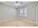 An empty bedroom features neutral walls, modern ceiling fan, and a large window at 216 Sharp Edge Ave, North Las Vegas, NV 89031