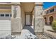 Inviting home entrance featuring a covered porch, decorative pillars, and a stylish front door at 216 Sharp Edge Ave, North Las Vegas, NV 89031