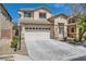 Inviting two-story home with a well-manicured lawn, a driveway, and an attached garage at 216 Sharp Edge Ave, North Las Vegas, NV 89031