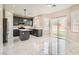 Bright eat-in kitchen features a center island, stainless appliances, and sliding glass doors to the backyard at 216 Sharp Edge Ave, North Las Vegas, NV 89031