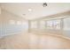 A spacious living room provides a multitude of large windows and light-toned wood floors at 216 Sharp Edge Ave, North Las Vegas, NV 89031