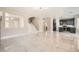 Open-concept living room with marble floors, stairs, and a view of the modern kitchen at 216 Sharp Edge Ave, North Las Vegas, NV 89031